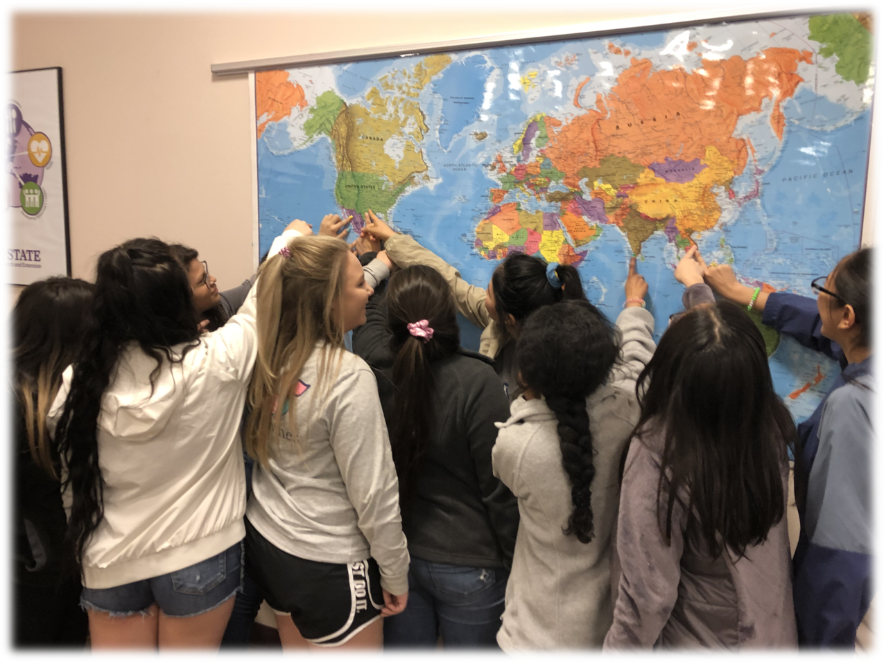 Girls pointing at map.jpg